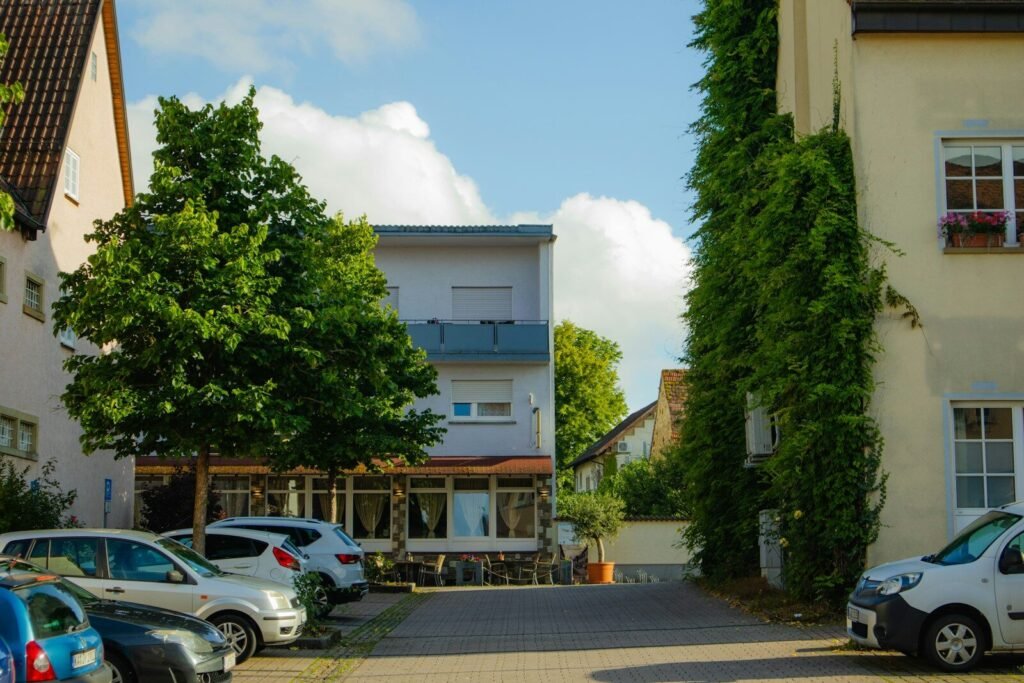 A street lined with parked cars next to tall buildings